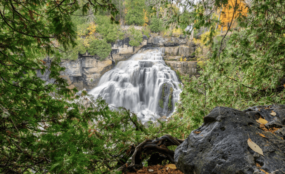 Waterfall cascading down rocks in a forested area
