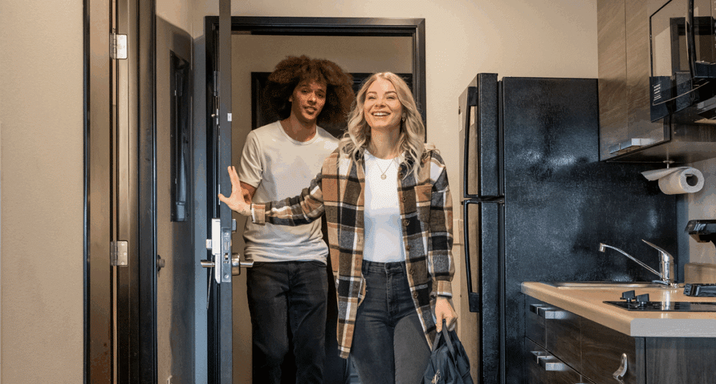 Couple walking into a My Place Hotel room